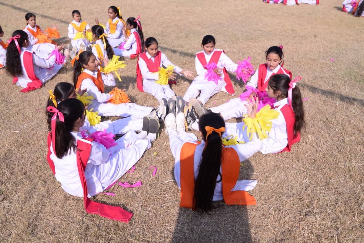 Young students in a PE activity on the sports ground
